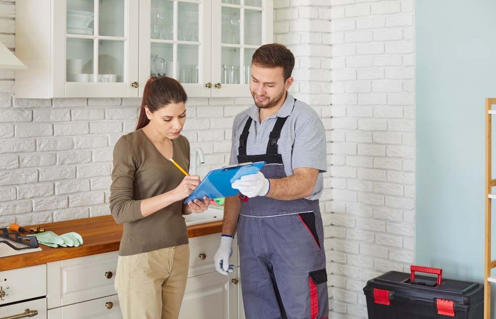 Plumber service, professional skilled male worker signing documents after fixing fit and repair pipe Plumber service, professional skilled male worker signing documents after fixing fit and repair pipes, fittings, water supply, sanitation, heating systems plumbing, sewage, heat pumps, installations